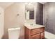Bathroom featuring a single sink vanity and gray shower tiles at 3225 Olive St, Denver, CO 80207