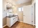Bright bathroom with double sink vanity, black countertop, and marble backsplash at 3225 Olive St, Denver, CO 80207