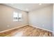 Well-lit bedroom featuring hardwood floors and a double window at 3225 Olive St, Denver, CO 80207