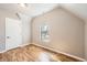Small bedroom featuring hardwood floors and a bright window at 3225 Olive St, Denver, CO 80207