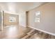 Bright bedroom with hardwood floors and ample natural light from two windows at 3225 Olive St, Denver, CO 80207