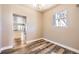 Dining room with wood floors and a large window overlooking the yard at 3225 Olive St, Denver, CO 80207