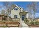 Charming two-story home featuring a cozy front porch and landscaped garden at 3225 Olive St, Denver, CO 80207