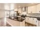 Modern kitchen with stainless steel appliances, white cabinets, and sleek countertops at 3225 Olive St, Denver, CO 80207