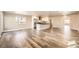 Spacious open-concept living area with a modern kitchen and hardwood floors at 3225 Olive St, Denver, CO 80207