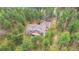 Stunning aerial view of a home featuring an expansive deck surrounded by green trees in a lush area at 1653 Gore Dr, Larkspur, CO 80118