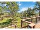 An outdoor view from the deck of a large backyard with grass and a shed among tall pine trees at 1653 Gore Dr, Larkspur, CO 80118