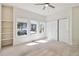 Well-lit bedroom featuring carpeted floors, closet with sliding doors, and view of the outside landscape at 1653 Gore Dr, Larkspur, CO 80118