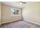 Bedroom with neutral paint, carpeted floors, a ceiling fan, and a view of trees through the large window at 1653 Gore Dr, Larkspur, CO 80118