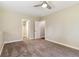 A bedroom with neutral walls and carpet, showcasing two entry doors and a walk-in closet at 1653 Gore Dr, Larkspur, CO 80118