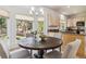 Bright breakfast nook with a round table, and views of the serene outdoor landscape at 1653 Gore Dr, Larkspur, CO 80118