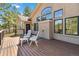 Exterior deck with white plastic chairs offers views of the home's architecture and surrounding pine trees at 1653 Gore Dr, Larkspur, CO 80118