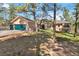 Charming house featuring a green garage door, stone driveway, and mature trees at 1653 Gore Dr, Larkspur, CO 80118