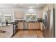 Well-lit kitchen featuring stainless steel appliances, granite countertops, and light wood cabinets at 1653 Gore Dr, Larkspur, CO 80118