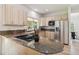 Open-concept kitchen with granite countertops, stainless steel appliances, and natural wood cabinets at 1653 Gore Dr, Larkspur, CO 80118