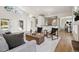 Open-concept living room with hardwood floors, neutral tones, and access to other living areas at 1653 Gore Dr, Larkspur, CO 80118