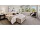 Airy main bedroom featuring an upholstered bench, and view of the pines outside the many windows at 1653 Gore Dr, Larkspur, CO 80118