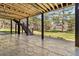 Covered outdoor patio featuring a stone surface, support beams, stairs, and views of pine trees at 1653 Gore Dr, Larkspur, CO 80118