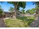 Spacious backyard with lush lawn, mature trees, and a charming patio area for outdoor enjoyment at 7092 E Mexico Ave, Denver, CO 80224