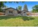 Well-maintained backyard with green grass, patio, and privacy fence, ideal for relaxing and entertaining guests at 7092 E Mexico Ave, Denver, CO 80224