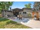 Backyard patio featuring an outdoor table and chairs, BBQ and green grass at 7092 E Mexico Ave, Denver, CO 80224