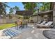 Backyard patio with seating, dining and green grass at 7092 E Mexico Ave, Denver, CO 80224