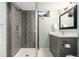 Modern bathroom featuring a glass enclosed shower and vanity with gray cabinets at 7092 E Mexico Ave, Denver, CO 80224
