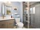 Contemporary bathroom with updated vanity, modern fixtures and a tiled walk-in shower at 7092 E Mexico Ave, Denver, CO 80224