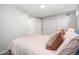 Bedroom with carpeted floors, closet and light pink bedding at 7092 E Mexico Ave, Denver, CO 80224