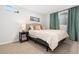 Cozy bedroom featuring carpeted floors, soft lighting, and two windows at 7092 E Mexico Ave, Denver, CO 80224