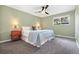 Comfortable bedroom features a queen-size bed, a ceiling fan and carpet floors at 7092 E Mexico Ave, Denver, CO 80224