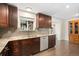 Gourmet kitchen featuring granite countertops, stainless steel appliances, and sleek dark wood cabinetry at 7092 E Mexico Ave, Denver, CO 80224