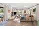 Bright living room with a fireplace, skylight, and sliding door to an outdoor seating area at 7092 E Mexico Ave, Denver, CO 80224
