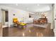 Open-concept living area featuring hardwood floors, modern furnishings, and access to the bathroom at 7092 E Mexico Ave, Denver, CO 80224