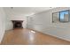 Cozy finished basement with fireplace and windows allowing natural light to illuminate the space at 6823 Coors St, Arvada, CO 80004