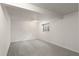 Finished basement with neutral colored carpet and a window at 6823 Coors St, Arvada, CO 80004