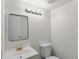 Powder room featuring a modern vanity, lighting, and neutral color scheme at 6823 Coors St, Arvada, CO 80004