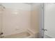 Bathroom featuring a tub shower with tile surround and an open doorway at 6823 Coors St, Arvada, CO 80004