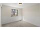 Bedroom with neutral walls, carpet, wainscoting, and natural light from one large window at 6823 Coors St, Arvada, CO 80004