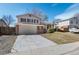 Charming two-story home with brick accents, a two-car garage, and a well-maintained front yard at 6823 Coors St, Arvada, CO 80004