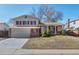 Charming two-story home with brick accents, a two-car garage, and a well-maintained front yard at 6823 Coors St, Arvada, CO 80004