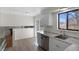 Clean, bright kitchen features a stainless steel dishwasher and a sink with modern fixture at 6823 Coors St, Arvada, CO 80004