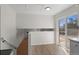Bright kitchen area with hardwood flooring and sliding glass doors leading to backyard at 6823 Coors St, Arvada, CO 80004