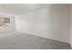 Spacious, carpeted living room with natural light from large windows and neutral walls at 6823 Coors St, Arvada, CO 80004