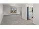 Bright, open living room with new carpet, two windows, and views that let in natural light at 6823 Coors St, Arvada, CO 80004