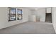 Bright living room with neutral carpet, large windows, and a staircase to the upper level at 6823 Coors St, Arvada, CO 80004