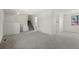Bright living room featuring neutral carpet, a staircase, and ample natural light at 6823 Coors St, Arvada, CO 80004