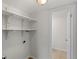 Bright pantry featuring functional open shelving and an doorway to the half bathroom at 6823 Coors St, Arvada, CO 80004