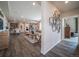 Bright hallway with wood floors, leading to the living and dining areas at 5152 N Quemoy Ct, Aurora, CO 80019