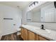 Bathroom features a framed mirror, wood-style flooring, and granite countertops at 19046 E 57Th Pl # B, Denver, CO 80249